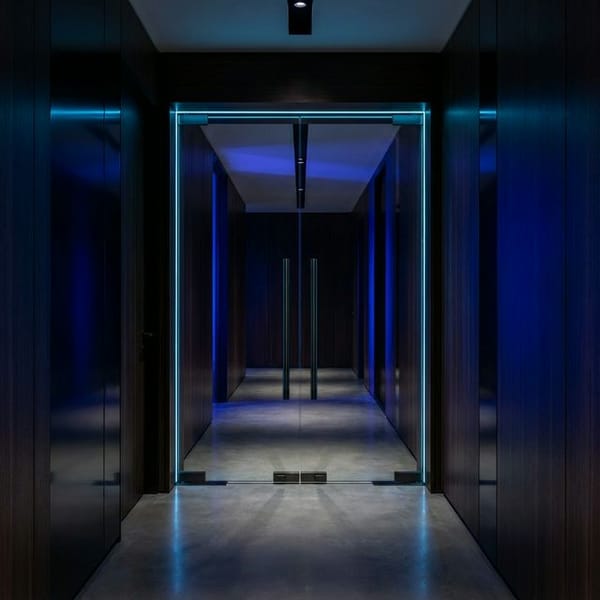 Elegant open doorway with warm light streaming through in a navy blue executive setting, representing the 70% Action Door decision framework